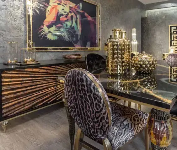 Black and gold striped sideboard below a tiger portrait, with leopard-print dining chairs at a glass table